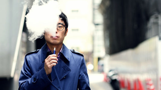 a man smoking a heat-not-burn tobacco vape device